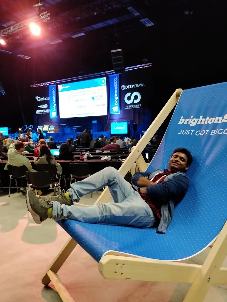 Thomas Androws relaxing in a giant brightonSEO deckchair in front of the main stage at brightonSEO 2018