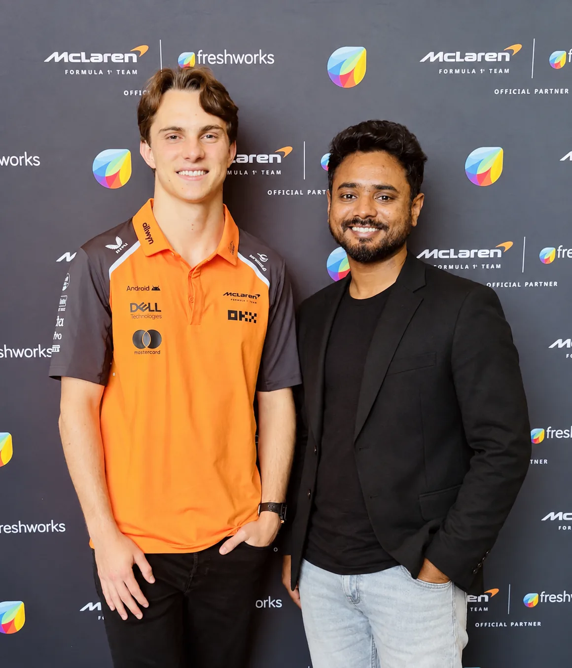 Thomas Androws with McLaren F1 driver Oscar Piastri in front of a McLaren and Freshworks partner backdrop